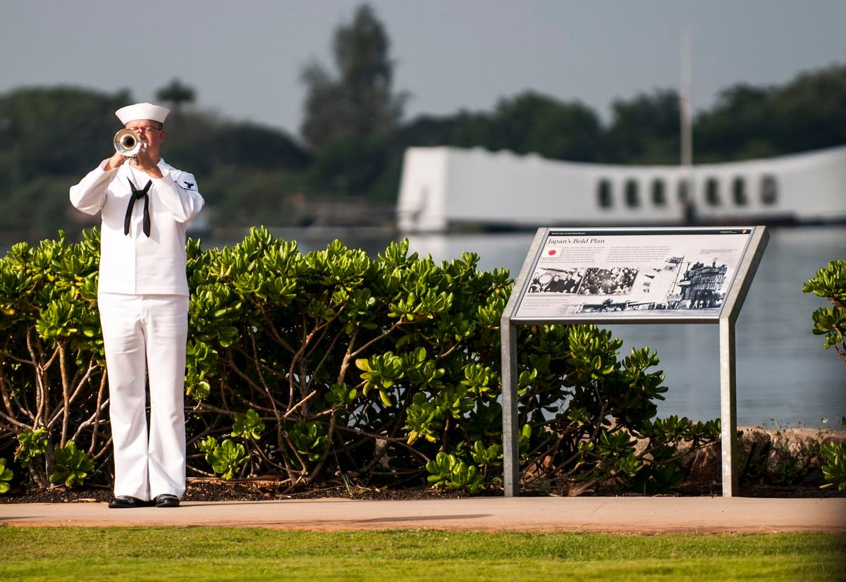 A U.S. Navy bugler plays taps during a Pearl Harbor Day 71st anniversary commemoration at the World War II Valor in the Pacific National Monument in Pearl Harbor, Hawaii, Dec. 7, 2012. More than 2000 guests attended the ceremony. The morning of Dec. 7, 1941, Japanese bombers staged a surprise attack on U.S. military forces in Hawaii. The day after the attack, before a joint session of Congress, President Franklin D. Roosevelt asked for a declaration of war against Japan and the U.S. officially entered World War II. (U.S. Navy photo by Mass Communication Specialist 3rd Class Dustin W. Sisco/Released)